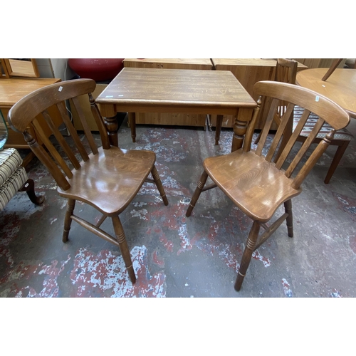 91 - A beech rectangular dining table and two chairs - approx. 74cm high x 65cm wide x 90cm long