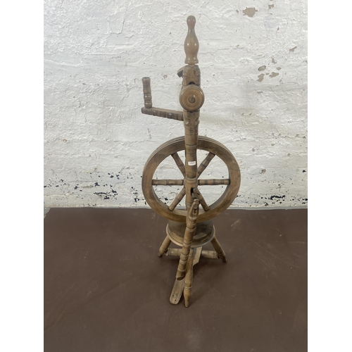 97 - A 19th century style beech spinning wheel - approx. 100cm high