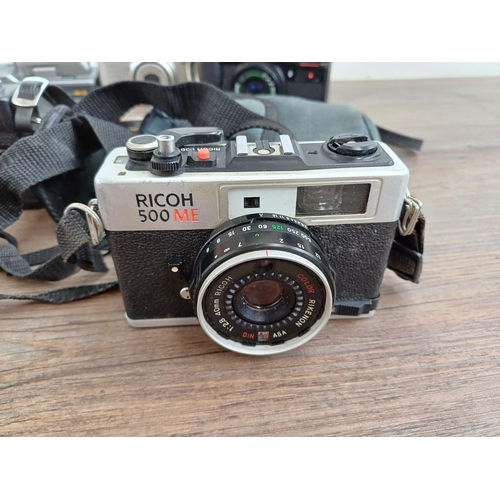 554 - Seven Ricoh compact cameras, one 500 ME 35mm rangefinder, one 35ZF 35mm viewfinder (A/F), one FF-3AF... 