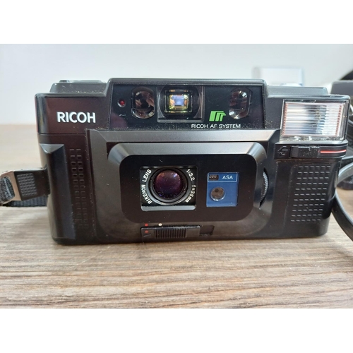 554 - Seven Ricoh compact cameras, one 500 ME 35mm rangefinder, one 35ZF 35mm viewfinder (A/F), one FF-3AF... 