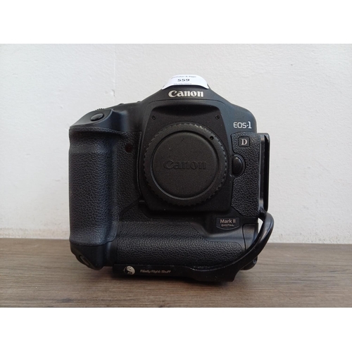 559 - A Canon EOS-1D Mark II 8mp professional DSLR camera body fitted with Really Right Stuff L-plate