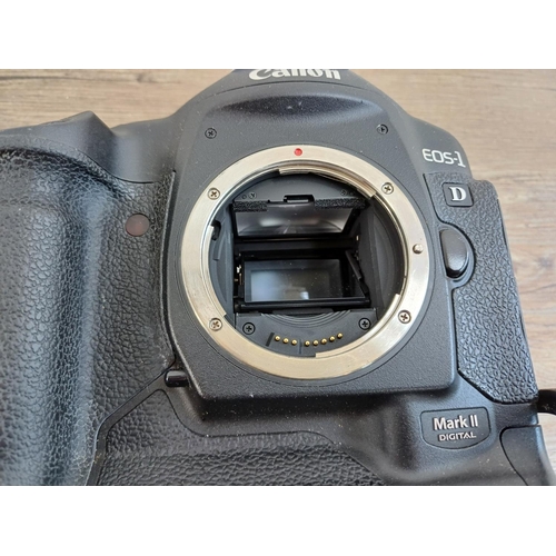 559 - A Canon EOS-1D Mark II 8mp professional DSLR camera body fitted with Really Right Stuff L-plate