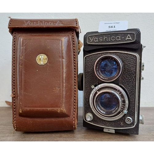 561 - A cased Yashica-A 6x6 TLR camera for 120 film fitted with Yashikor 1:3.5 f=80mm lenses and Copal shu... 