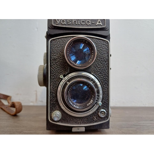 561 - A cased Yashica-A 6x6 TLR camera for 120 film fitted with Yashikor 1:3.5 f=80mm lenses and Copal shu... 