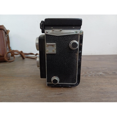 561 - A cased Yashica-A 6x6 TLR camera for 120 film fitted with Yashikor 1:3.5 f=80mm lenses and Copal shu... 