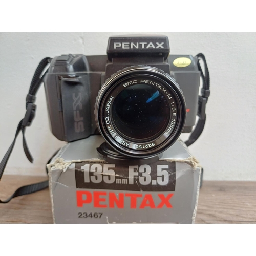 565 - Three Pentax 35mm SLR cameras, one SFXN autofocus fitted with Pentax-M 135mm 1:3.5 lens, one MZ-10 f... 