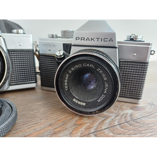 567 - Three Praktica 35mm SLR cameras, one cased TL3 fitted with Carl Zeiss Tessar 2.8/50 lens, one MTL3 f... 