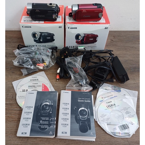 569 - Two boxed Canon Legria digital camcorders with software discs, accessories and instruction manuals, ... 