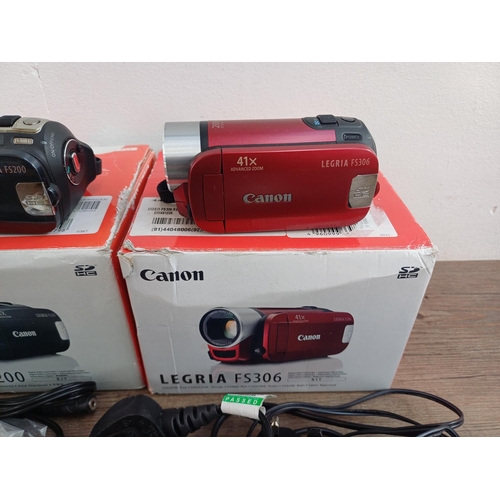 569 - Two boxed Canon Legria digital camcorders with software discs, accessories and instruction manuals, ... 