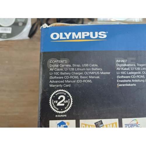 571 - Two boxed compact digital cameras, one Olympus µ[mju:] Digital 800 all-weather 8mp with software dis... 