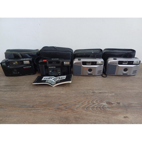 574 - Four cased Olympus Trip compact 35mm cameras, one AF MD with instruction manual, one AF S-2 and two ... 