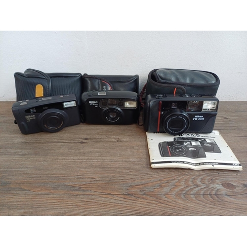 576 - Three cased Nikon compact autofocus 35mm cameras, one TW Zoom with instruction manual, one Zoom 500 ... 