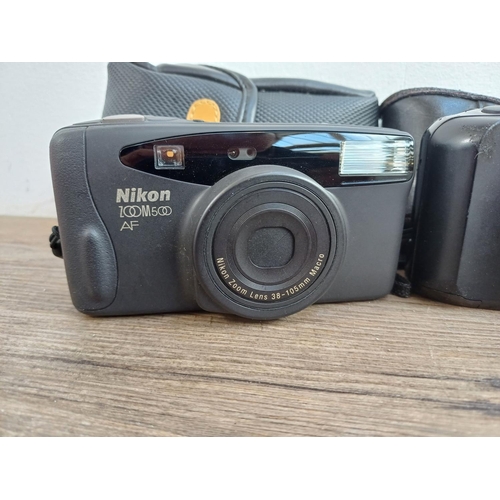 576 - Three cased Nikon compact autofocus 35mm cameras, one TW Zoom with instruction manual, one Zoom 500 ... 