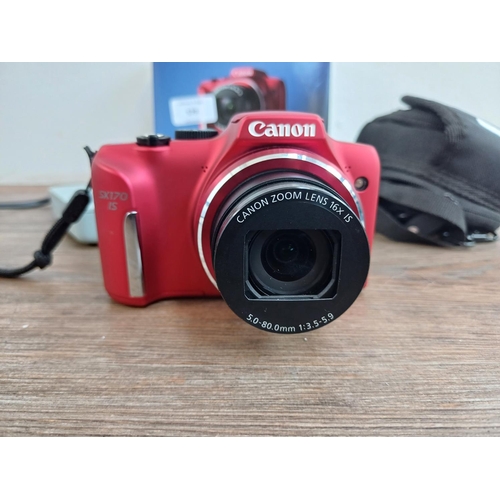 579 - A boxed and cased Canon PowerShot SX170 IS 16mp compact digital camera with charger