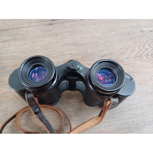 581 - A cased pair of vintage Carl Zeiss Jenoptem 8x30W binoculars