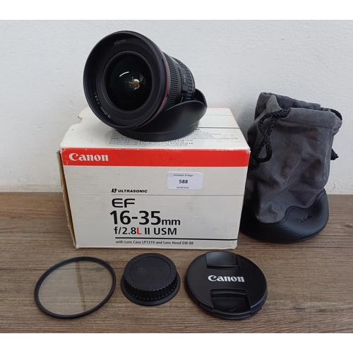 588 - A boxed Canon Ultrasonic (red) L-series EF 16-35mm 1:2.8 L II USM zoom lens with EW-88 lens hood and... 