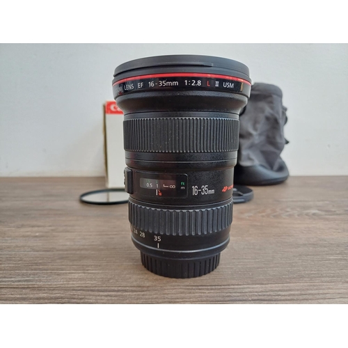 588 - A boxed Canon Ultrasonic (red) L-series EF 16-35mm 1:2.8 L II USM zoom lens with EW-88 lens hood and... 