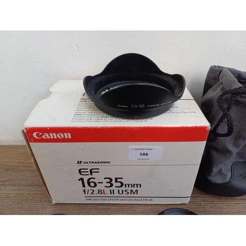 588 - A boxed Canon Ultrasonic (red) L-series EF 16-35mm 1:2.8 L II USM zoom lens with EW-88 lens hood and... 