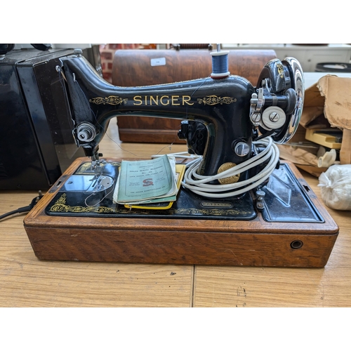 748 - A cased 1935 Singer 99K electric sewing machine with instruction manual and accessories