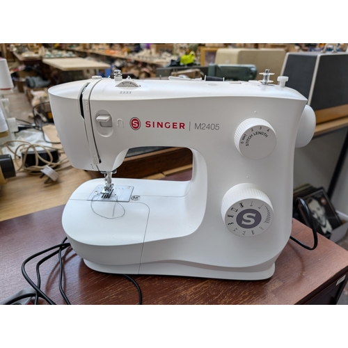 753 - Two items, one boxed Singer M2405 electric sewing machine with foot pedal and instruction manual and... 