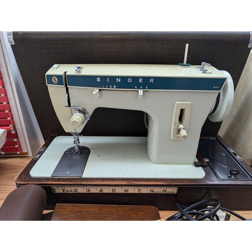 762 - A cased Singer 257 electric sewing machine with foot pedal, attachments and instruction manual