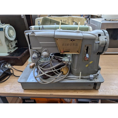 763 - Two cased vintage electric sewing machines with foot pedals, one Singer 328K and one Jones 222