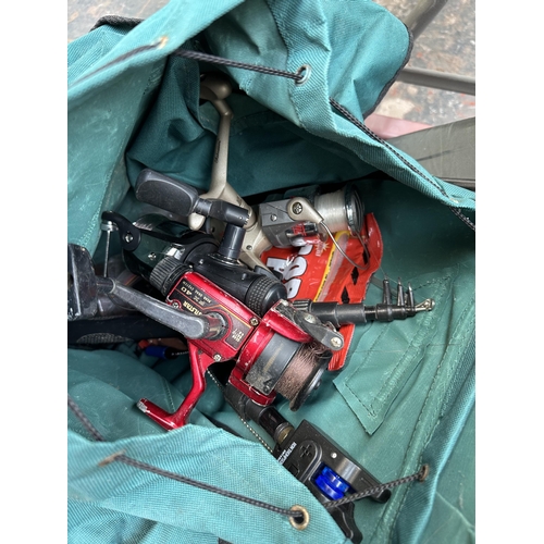 1013 - A collection of fishing equipment and tackle to include Mitchell TGR-5000 R reel, two Max carp reels... 