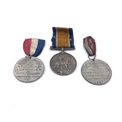 2167 - A collection of medals and badges to include WWI British medal pair presented to 35983 Pte. A. Mouls... 