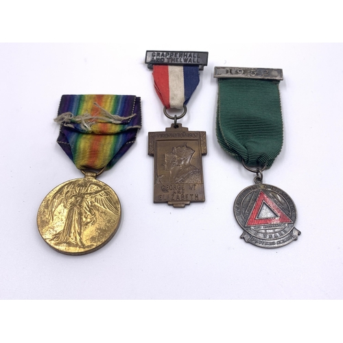 2167 - A collection of medals and badges to include WWI British medal pair presented to 35983 Pte. A. Mouls... 