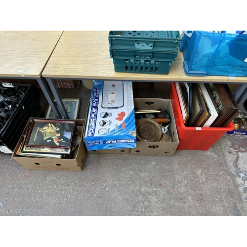 1105 - Four boxes containing framed pictures, ceramic book ends, Power Play table top air hockey etc.