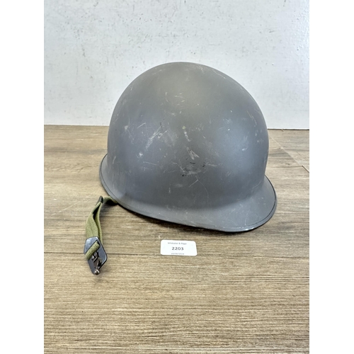 2203 - A Danish M48 M1 style civil defence helmet with CF stamp to interior and liner