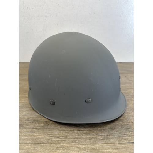 2203 - A Danish M48 M1 style civil defence helmet with CF stamp to interior and liner