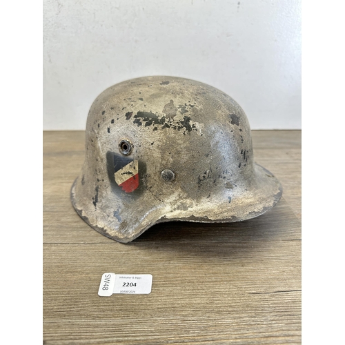 2204 - A reproduction WWII German M35 double decal helmet