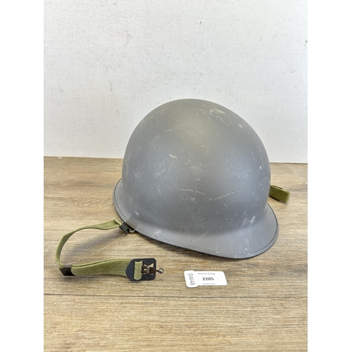 2205 - A Danish M48 M1 style civil defence helmet with CF stamp to interior and liner