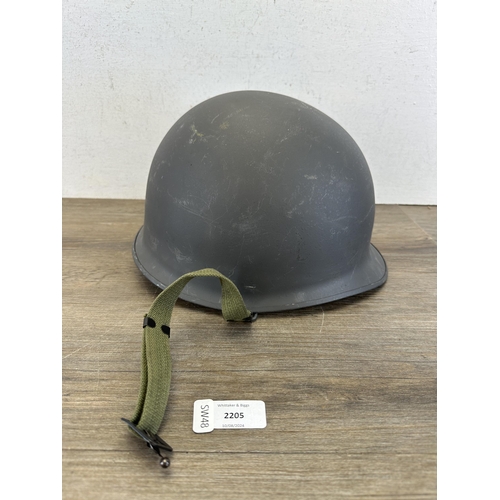 2205 - A Danish M48 M1 style civil defence helmet with CF stamp to interior and liner