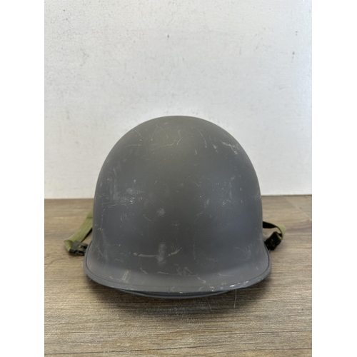 2205 - A Danish M48 M1 style civil defence helmet with CF stamp to interior and liner