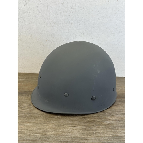 2205 - A Danish M48 M1 style civil defence helmet with CF stamp to interior and liner