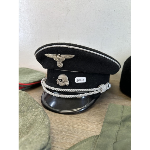 2212 - Eleven military caps to include reproduction WWII SS peaked cap, reproduction WWII German M43 field ... 