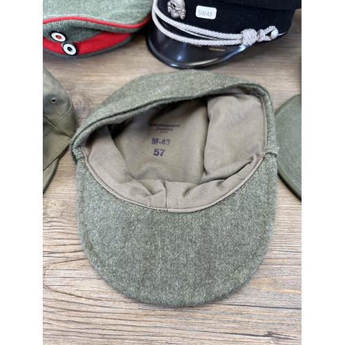 2212 - Eleven military caps to include reproduction WWII SS peaked cap, reproduction WWII German M43 field ... 