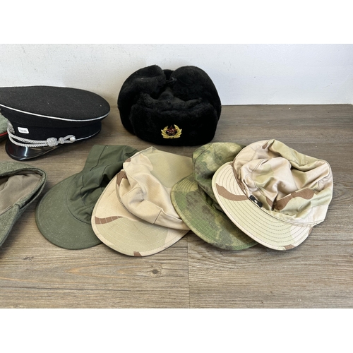 2212 - Eleven military caps to include reproduction WWII SS peaked cap, reproduction WWII German M43 field ... 