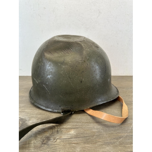 2213 - A WWII US M1 helmet with liner with Belgian M51 liner