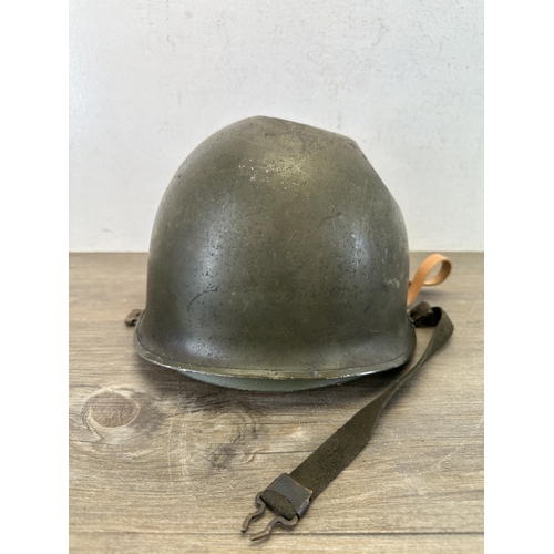 2213 - A WWII US M1 helmet with liner with Belgian M51 liner