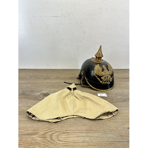 2214 - A reproduction WWI Prussian Pickelhaube helmet with canvas cover