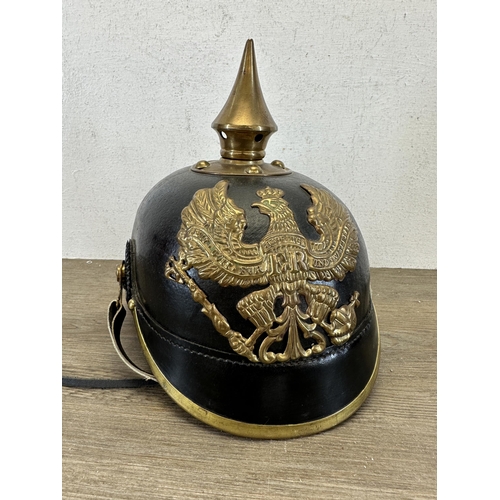 2214 - A reproduction WWI Prussian Pickelhaube helmet with canvas cover