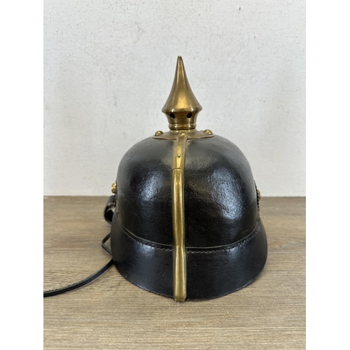 2214 - A reproduction WWI Prussian Pickelhaube helmet with canvas cover