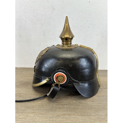 2214 - A reproduction WWI Prussian Pickelhaube helmet with canvas cover