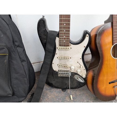 650 - Four musical instruments, one cased Music Alley child's nylon strung guitar, one Westwood stratocast... 