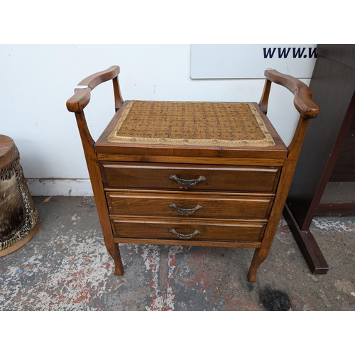 651 - An Edwardian wooden twin handled piano stool with three fall-front drawers with contents