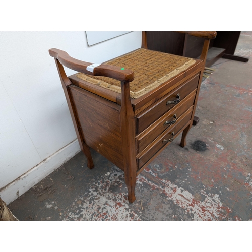 651 - An Edwardian wooden twin handled piano stool with three fall-front drawers with contents