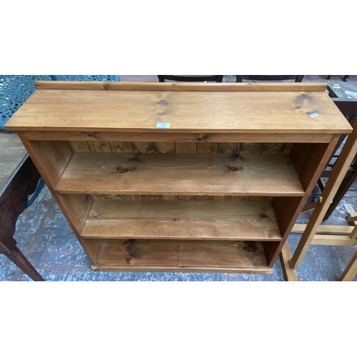 154 - A pine three tier bookcase - approx. 92cm high x 97cm wide x 23cm deep